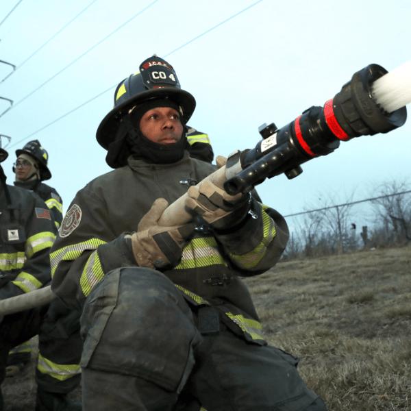 Fireman spraing a hose