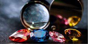 Closeup of some gemstones and an eyeglass