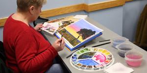 Woman working with watercolor to create a painting