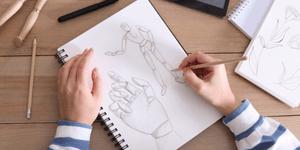 Woman drawing a hand and figure in pencil with shading