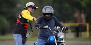 Female Instructor guiding a male motorcyle rider
