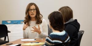 Three women around a table doing civil mediation training