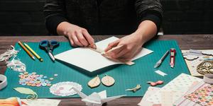 Someone wrking with various materials to create a unique book.